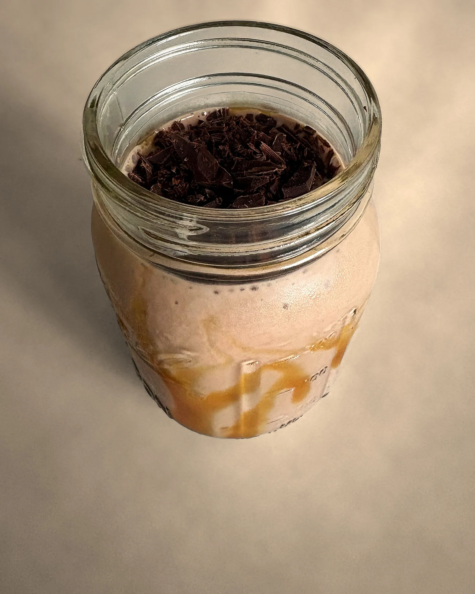 chocolate banana smoothie topped with dark chocolate shavings